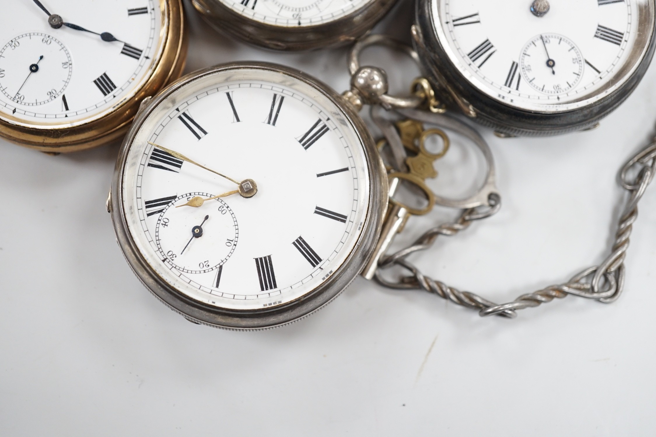 Three white metal open face pocket watches including two silver, one Waltham and a gold plated pocket watch.